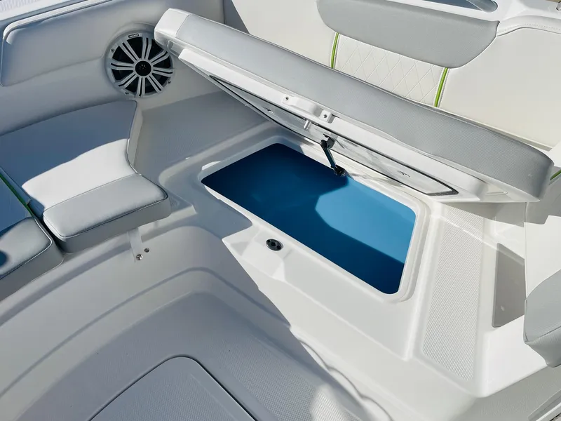 Slide: The Image of 2024 Tahoe 2150 CC boat with open storage compartment and speaker. - 14