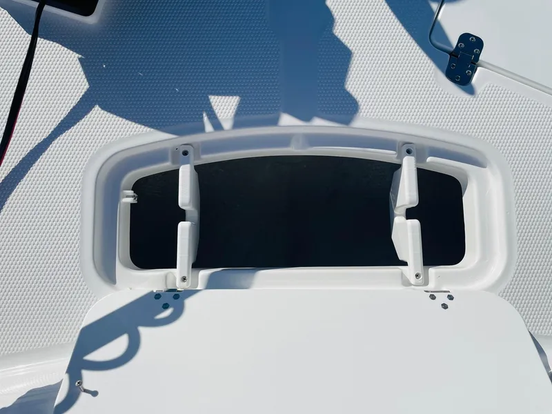 Slide: The Image of 2024 Tahoe 2150 CC boat deck hatch with open storage compartment. - 17