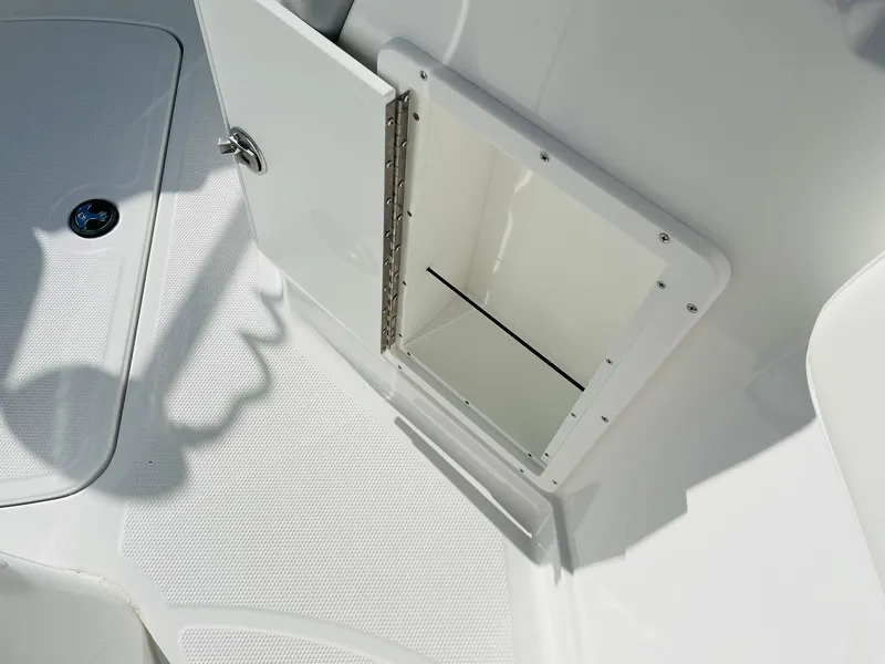 Slide: The Image of 2024 Tahoe 2150 CC boat storage compartment with open hatch. - 22