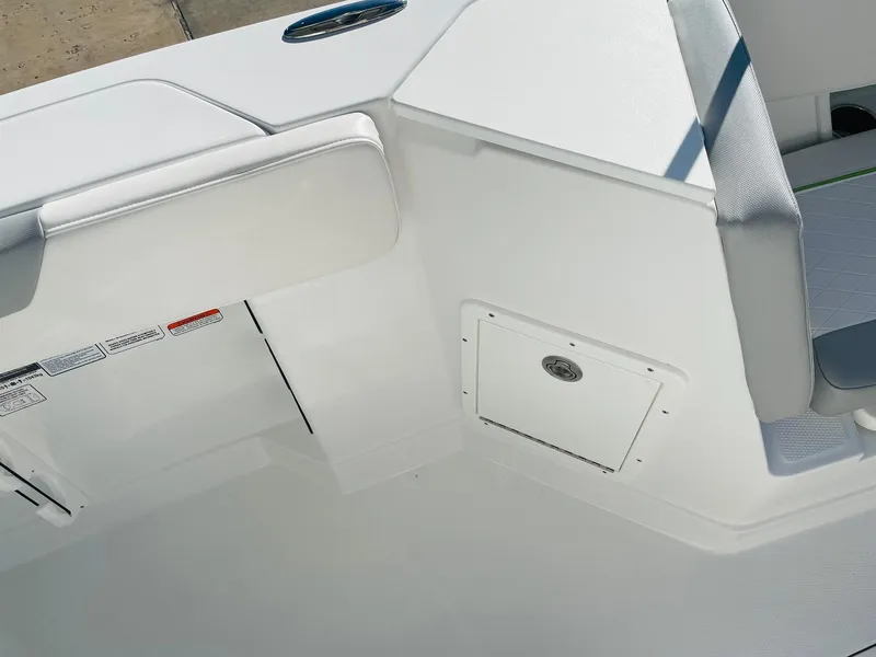 Slide: The Image of 2024 Tahoe 2150 CC boat interior, featuring white seating and storage compartments. - 23