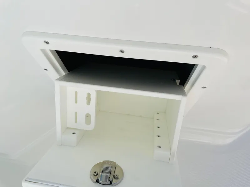 Slide: The Image of 2024 Tahoe 2150 CC storage compartment with latch. - 25