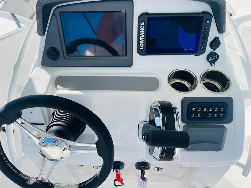 Slide: The Image of 2024 Tahoe 2150 CC boat dashboard with steering wheel, Lowrance display, and control panel. - 26