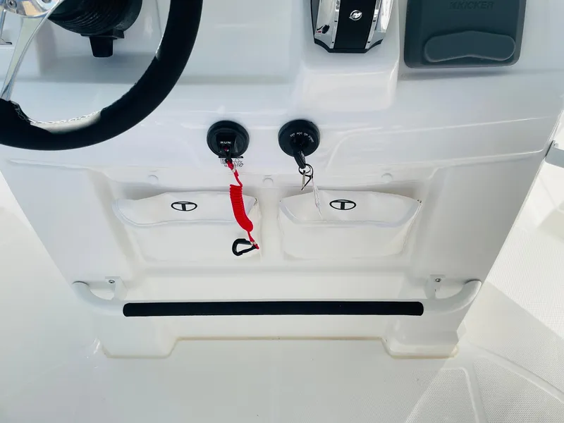Slide: The Image of 2024 Tahoe 2150 CC boat console with steering wheel and control panel. - 28