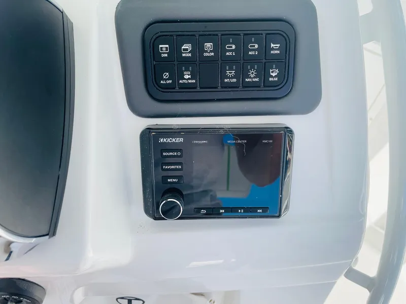 Slide: The Image of 2024 Tahoe 2150 CC boat control panel with Kicker audio system. - 29