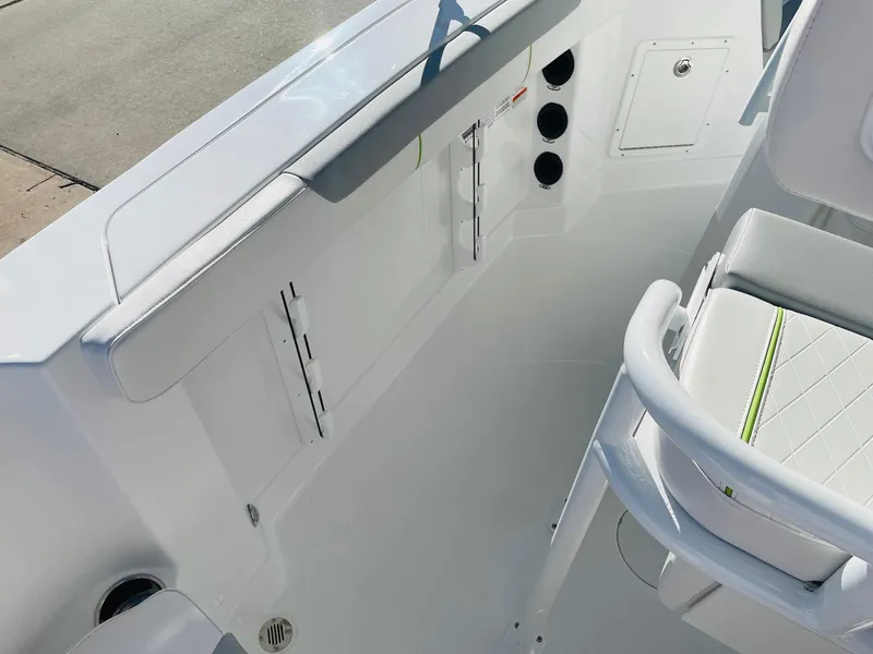 Slide: The Image of 2024 Tahoe 2150 CC boat interior, featuring clean white deck and seating. - 30