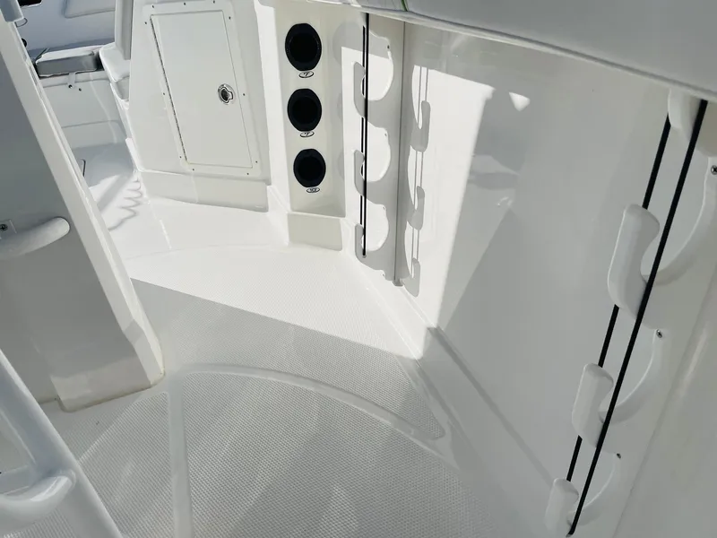 Slide: The Image of 2024 Tahoe 2150 CC boat interior with rod holders and storage compartments. - 33