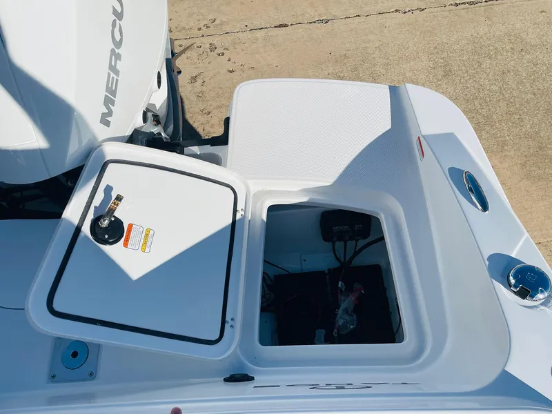 Slide: The Image of 2024 Tahoe 2150 CC boat with open storage compartment and Mercury engine. - 41