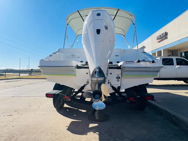 Slide: The Image of 2024 Tahoe 2150 CC boat with outboard motor, parked on a trailer. - 6