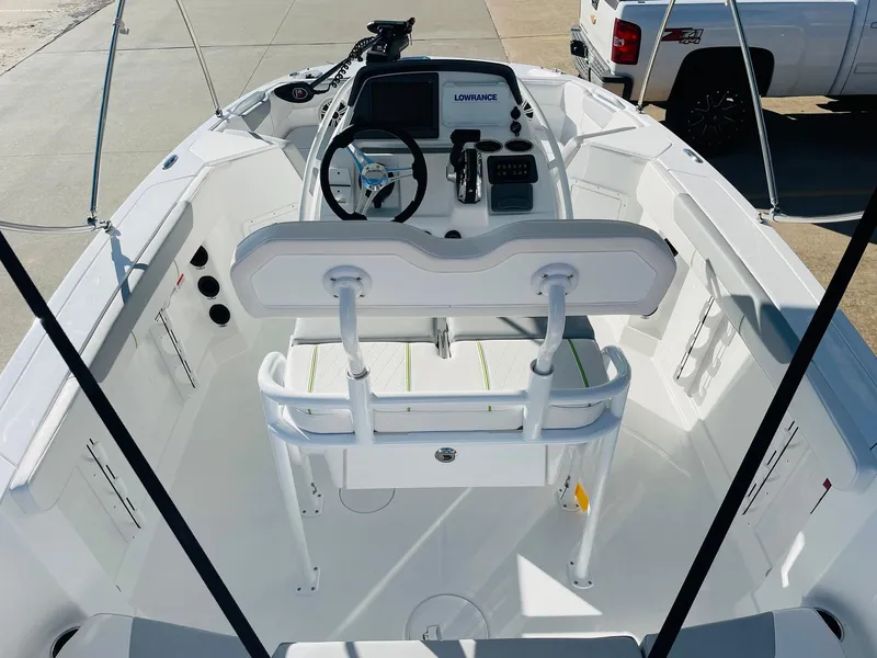 Slide: The Image of 2024 Tahoe 2150 CC boat interior with steering console and seating. - 7