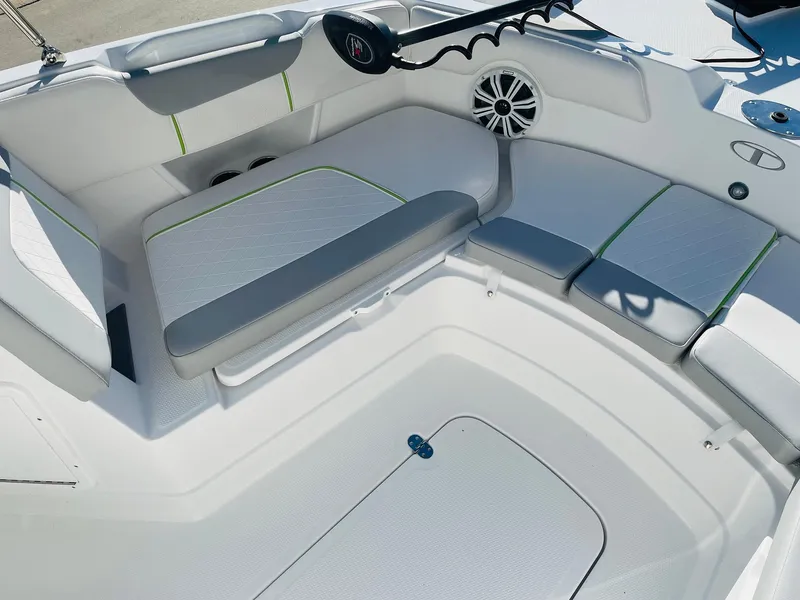 Slide: The Image of 2024 Tahoe 2150 CC boat interior with cushioned seating and storage compartments. - 9