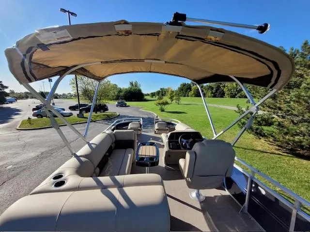 Slide: The Image of 2024 Sun Tracker Fishin' Barge 20 DLX pontoon boat with canopy and seating. - 5
