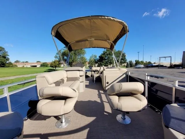 Slide: The Image of 2024 Sun Tracker Fishin' Barge 20 DLX pontoon boat with beige seating and canopy. - 6