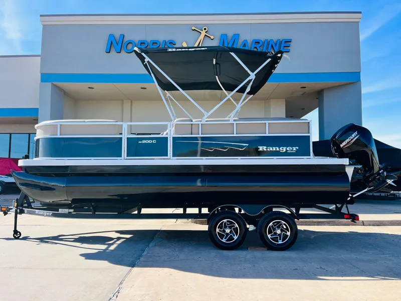 Slide: The Image of 2024 Ranger Reata 200C pontoon boat at Norris Marine dealership. - 1