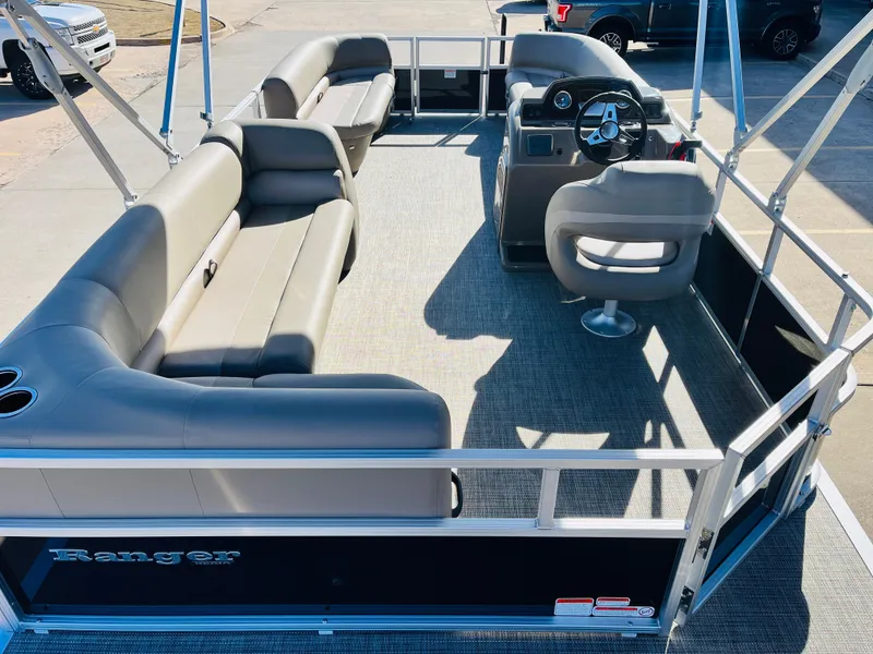 Slide: The Image of 2024 Ranger Reata 200C pontoon boat interior with seating and steering console. - 10
