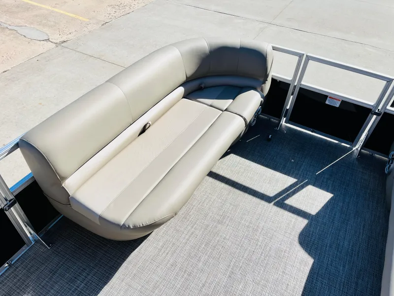 Slide: The Image of 2024 Ranger Reata 200C pontoon boat with beige seating and gray flooring. - 11