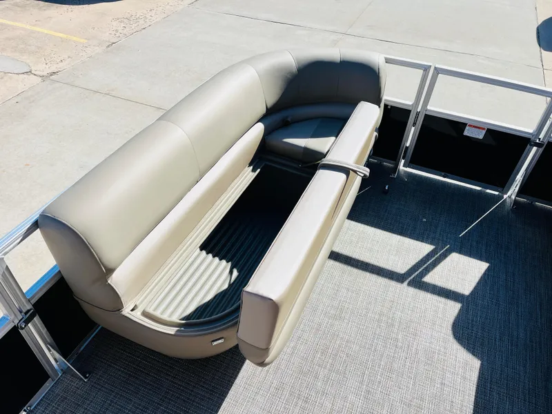 Slide: The Image of 2024 Ranger Reata 200C pontoon boat with gray seating and open storage compartment. - 12