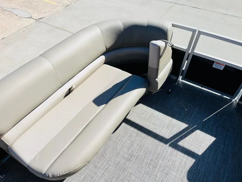 Slide: The Image of 2024 Ranger Reata 200C pontoon boat with beige seating and gray flooring. - 14