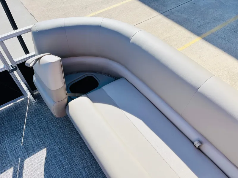 Slide: The Image of 2024 Ranger Reata 200C boat interior with cushioned seating and cup holder. - 21