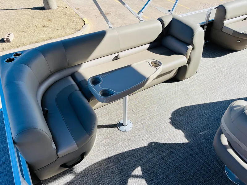Slide: The Image of 2024 Ranger Reata 200C boat interior with gray seating and table. - 23