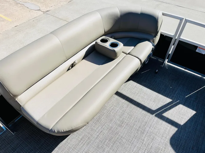 Slide: The Image of 2024 Ranger Reata 200C boat with beige cushioned seating and cup holders. - 45