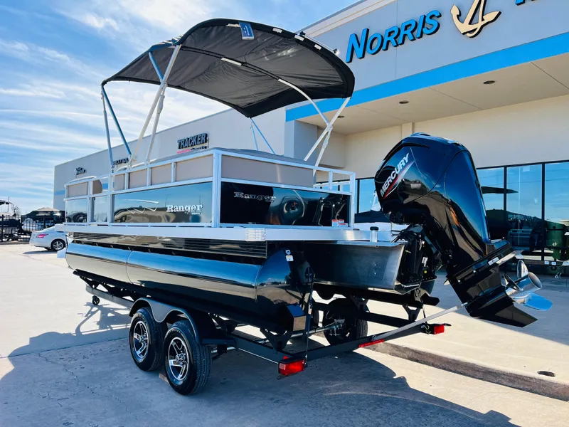 Slide: The Image of 2024 Ranger Reata 200C pontoon boat with Mercury outboard motor at dealership. - 8