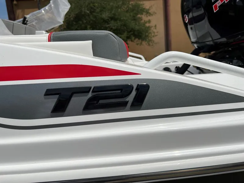 Slide: The Image of 2024 Tahoe T21 boat side view with model name and sleek design. - 10
