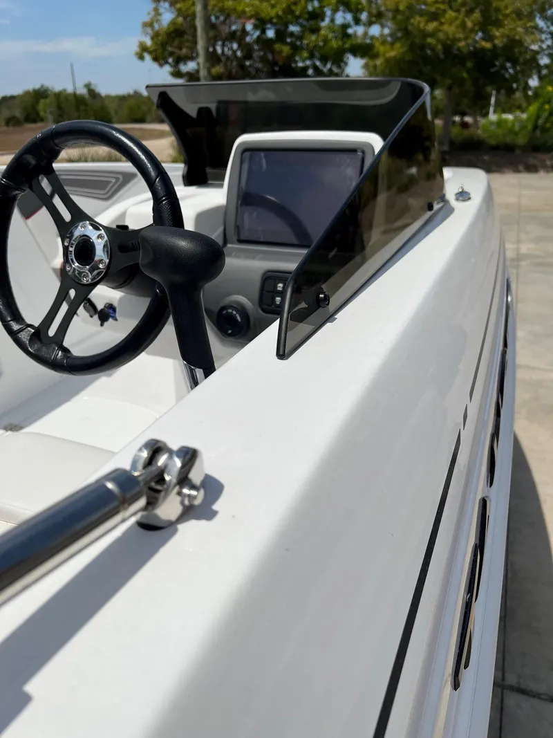 Slide: The Image of 2024 Tahoe T21 boat dashboard and steering wheel close-up. - 6