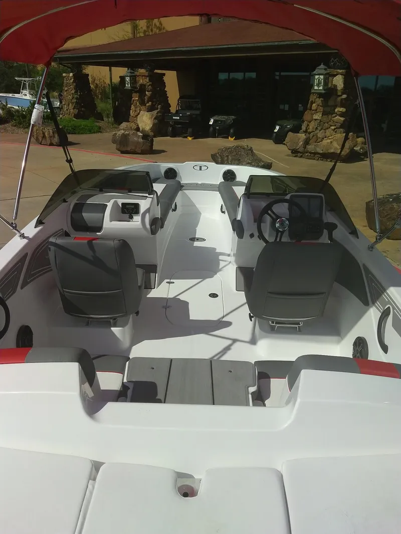 Slide: The Image of 2024 Tahoe T21 boat interior with dual seating and steering console. - 8