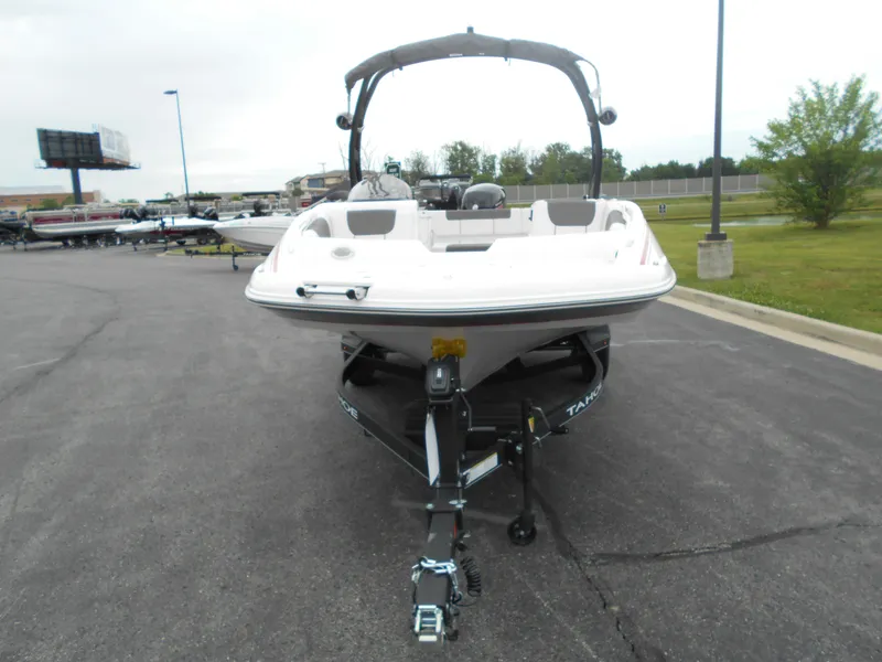 Slide: The Image of 2024 Tahoe 1950 boat on trailer in parking lot. - 3