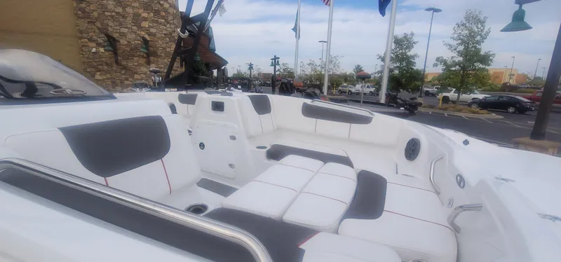Slide: The Image of 2024 Tahoe 1950 boat interior with white and gray seating, outdoor display. - 6