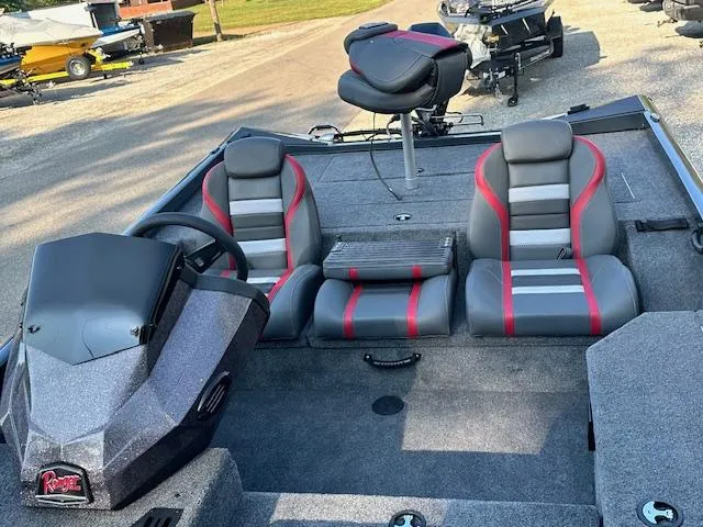Slide: The Image of 2024 Ranger RT178 boat interior with gray and red seating, steering console, and fishing seat. - 10
