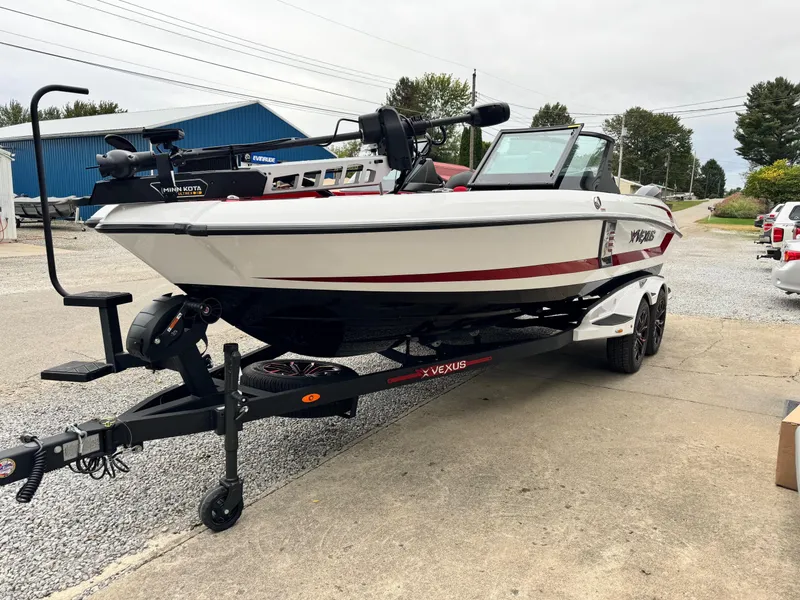 Slide: The Image of 2024 Vexus DVX20S boat on trailer, white with red accents, parked outdoors. - 11