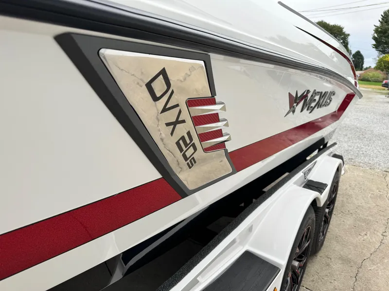 Slide: The Image of 2024 Vexus DVX20S boat, white with red accents, on a trailer. - 12
