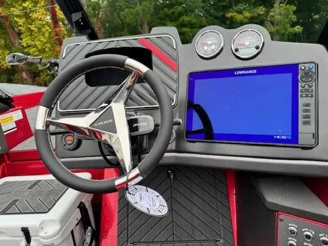 Slide: The Image of 2024 Vexus DVX20S boat dashboard with steering wheel and Lowrance display. - 6