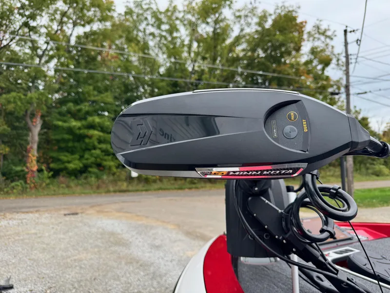 Slide: The Image of 2024 Vexus DVX20S boat with Minn Kota trolling motor, outdoors with trees in background. - 9