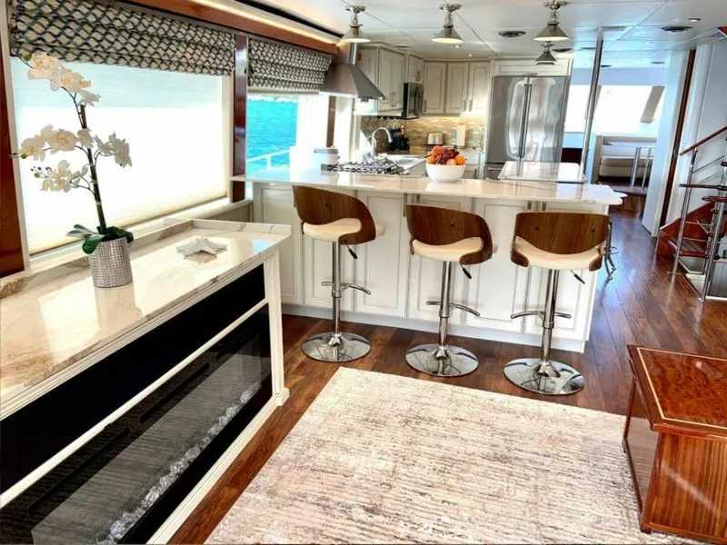 Slide: The Image of Luxurious interior of 1998 Cheoy Lee 81 Motor Yacht with modern kitchen and bar stools. - 5