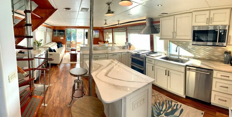 Slide: The Image of Interior of 1998 Cheoy Lee 81 Motor Yacht with modern kitchen and wooden flooring. - 6