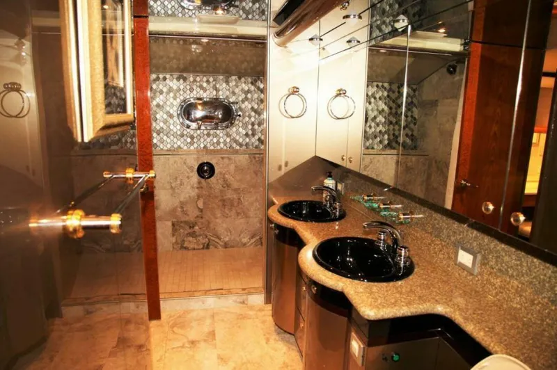 Slide: The Image of Luxurious bathroom in a 1998 Cheoy Lee 81 Motor Yacht with dual sinks and a spacious shower. - 8