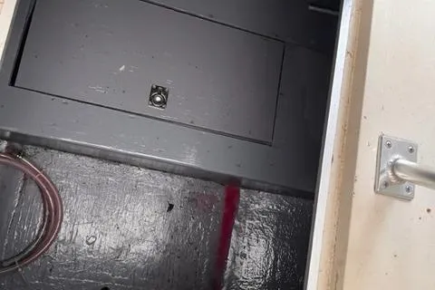 Slide: The Image of Interior view of a 1973 Formula Thunderbird 26 boat compartment with a hatch and handle. - 12