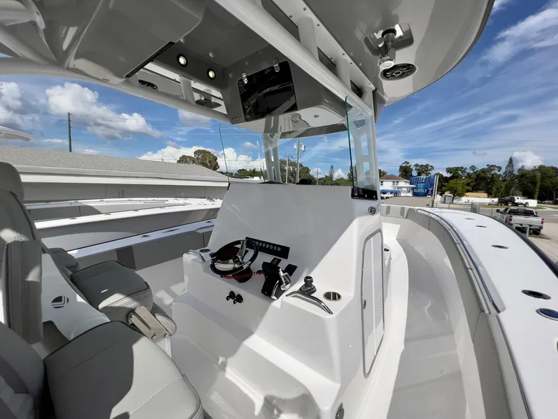 Slide: The Image of 2025 Cape Horn 39 T boat interior with modern helm and seating under clear blue sky. - 18