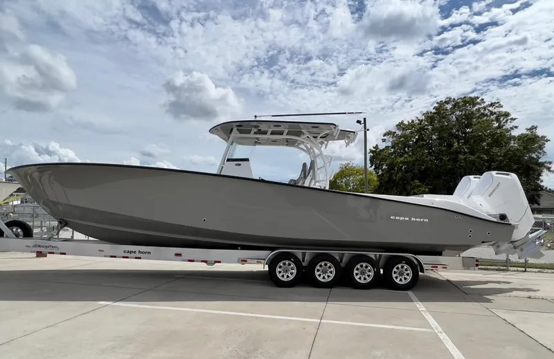 Slide: The Image of 2025 Cape Horn 39 T boat on trailer, parked outdoors under cloudy sky. - 2