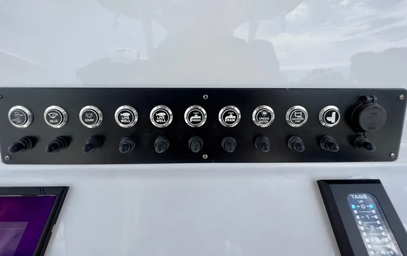 Slide: The Image of Control panel of 2025 Cape Horn 39 T boat with labeled switches and digital display. - 21