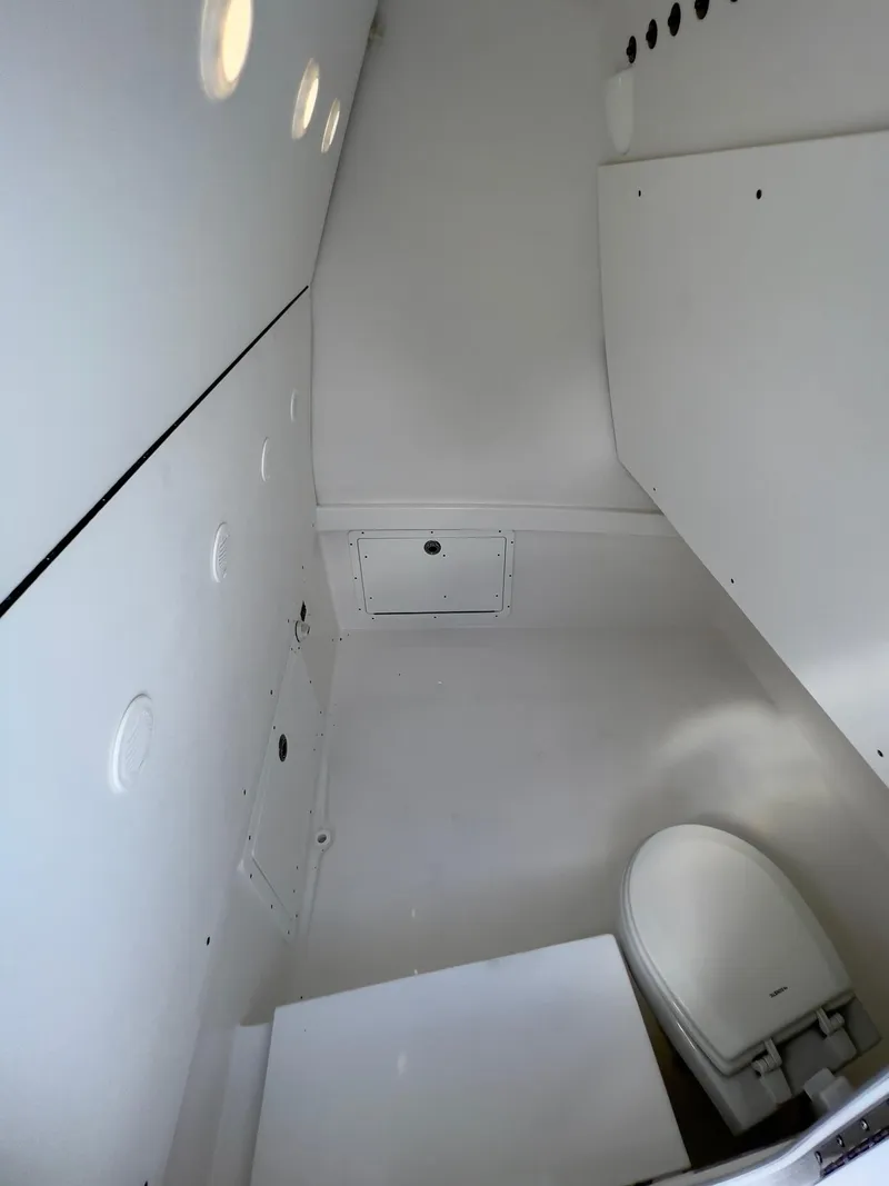 Slide: The Image of Interior of a 2025 Cape Horn 39 T boat, featuring a compact, white marine toilet. - 25
