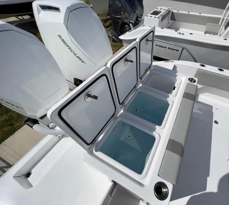 Slide: The Image of 2025 Cape Horn 39 T boat with open storage compartments and Mercury engines. - 29