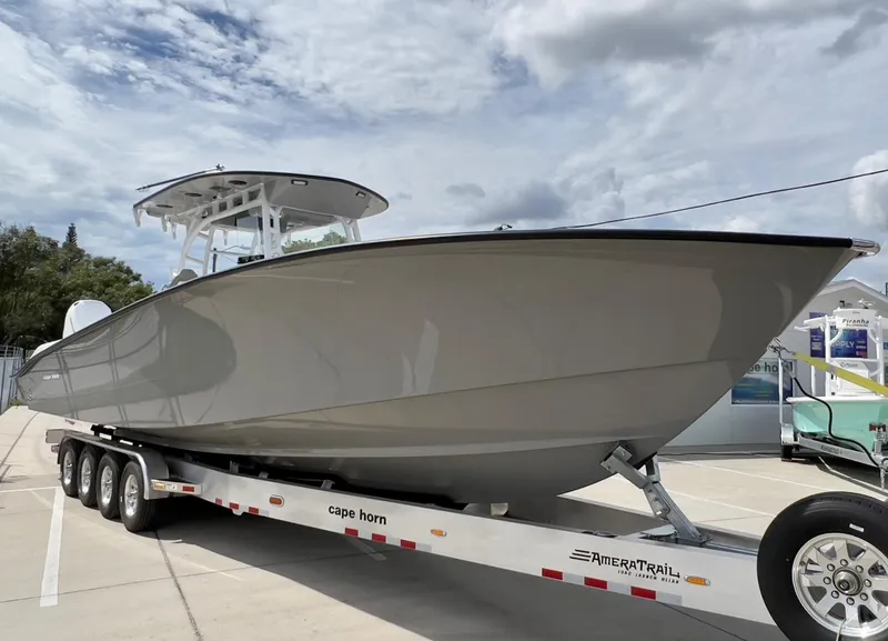 Slide: The Image of 2025 Cape Horn 39 T boat on trailer, displayed outdoors under cloudy sky. - 6