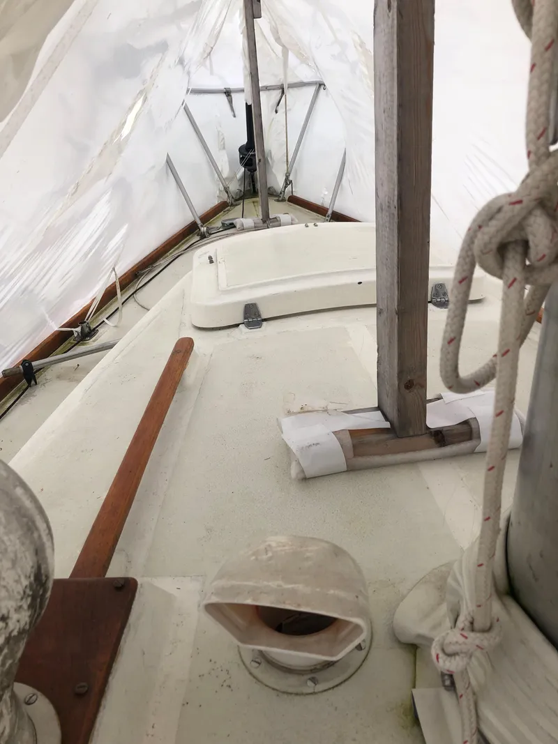 Slide: The Image of 1976 Tartan 30 sailboat deck under protective cover, showcasing mast and rigging details. - 10