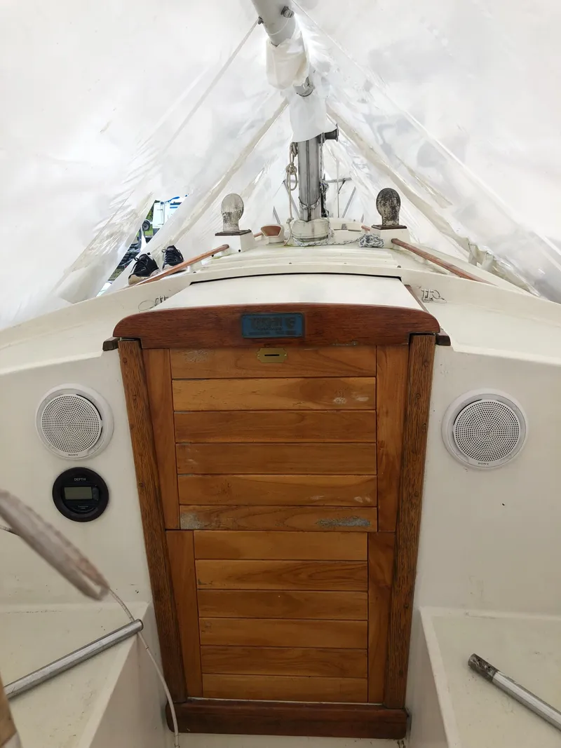 Slide: The Image of 1976 Tartan 30 sailboat interior with wooden hatch and white canopy. - 17