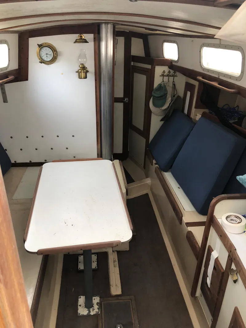 Slide: The Image of 1976 Tartan 30 sailboat interior with table, seating, and nautical decor. - 18