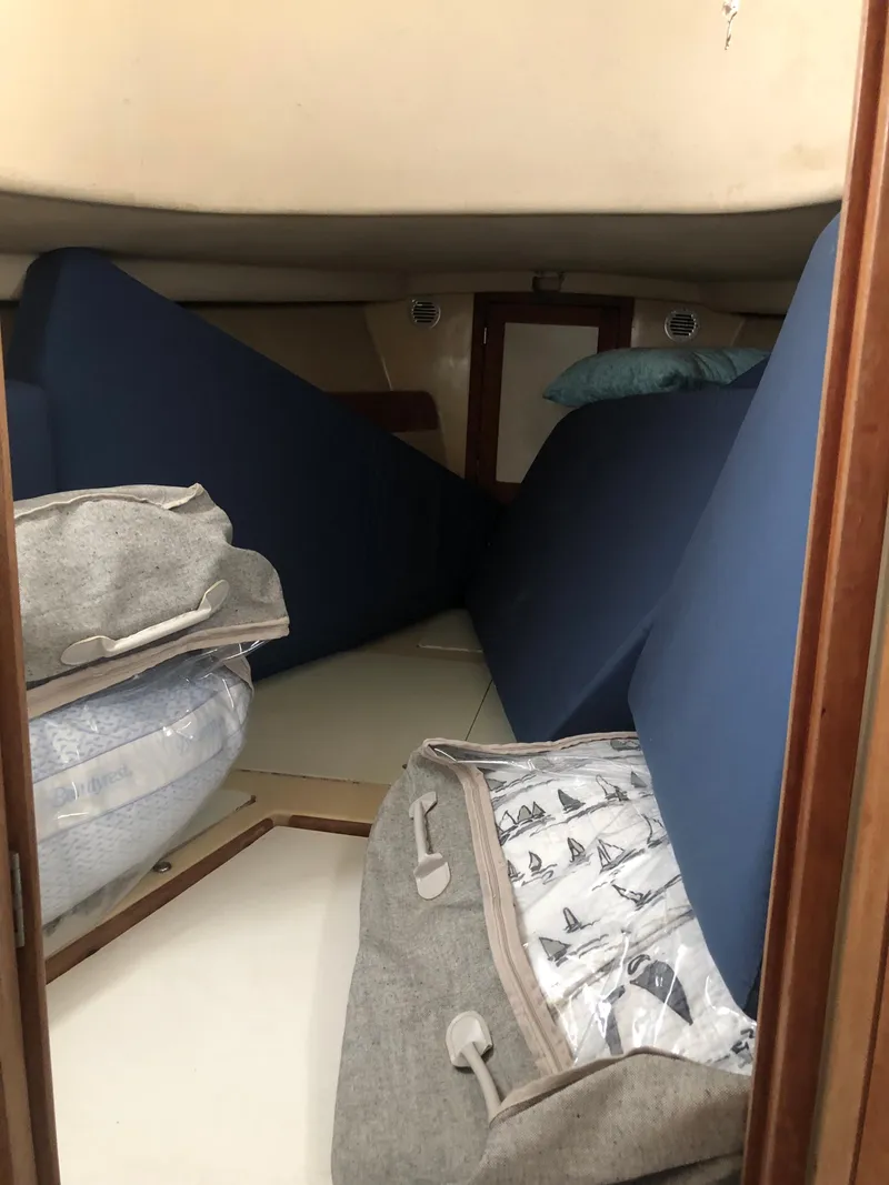Slide: The Image of Interior cabin of a 1976 Tartan 30 sailboat with cushions and bedding. - 23