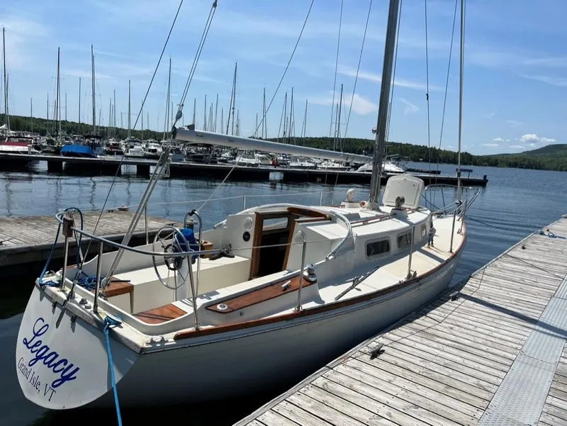 Slide: The Image of 1976 Tartan 30 sailboat docked at marina, clear sky, calm water. - 39